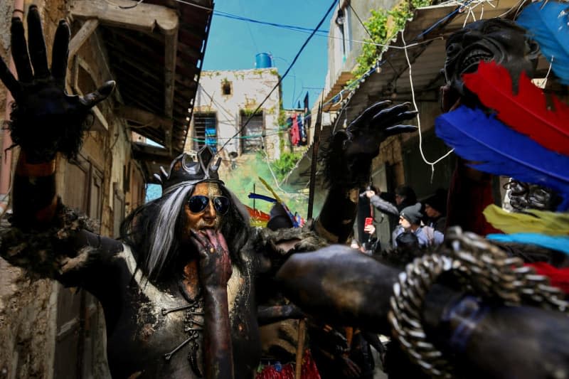 Revellers take part in the Zambo Carnival, to mark the last period of excess on the eve of the Christian Greek Orthodox lent, despite an acute economic meltdown, political impasse and fear of an open scale Israeli war on Lebanon. Marwan Naamani/dpa