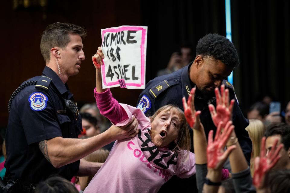 October 31, 2023: A protestor calling for a ceasefire in Gaza yells as she is escorted out of the room by Capitol Police during a Senate Appropriations Committee hearing with U.S. Secretary of State Antony Blinken and U.S. Secretary of Defense Lloyd Austin in Washington, DC. Protestors repeatedly interrupted the hearing. Blinken and Austin both testified at the hearing on budget requests, which included aid money for Israel and Ukraine.