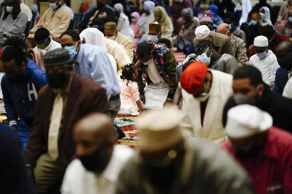 Worshippers perform an Eid al-Fitr prayer at the Masjidullah Mosque in Philadelphia, Thursday, May 13, 2021. Millions of Muslims across the world are marking a muted and gloomy holiday of Eid al-Fitr, the end of the fasting month of Ramadan - a usually joyous three-day celebration that has been significantly toned down as coronavirus cases soar. (AP Photo/Matt Rourke)