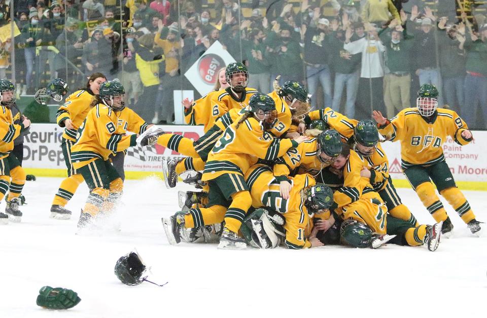 The BFA Comets celebrate mob goalie Makenna Montgomery moments after their 3-2 win over Spaulding in the D1 Championship game at UVM's Gutterson Fieldhouse.