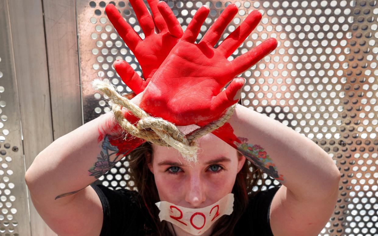 A woman wears a sticker marking the number of days hostages have been held by Hamas