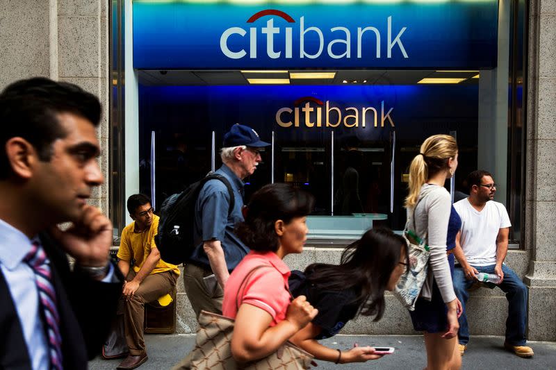 FILE PHOTO: Pedestrians walk past the facade of a Citibank building in New York