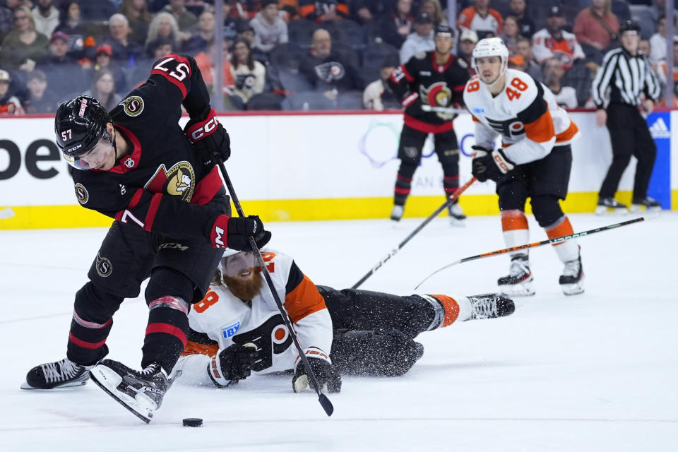 Ottawa Senators' Shane Pinto, left, slips past Philadelphia Flyers' Marc Staal during the third period of an NHL hockey game, Saturday, March 2, 2024, in Philadelphia. (AP Photo/Matt Slocum)