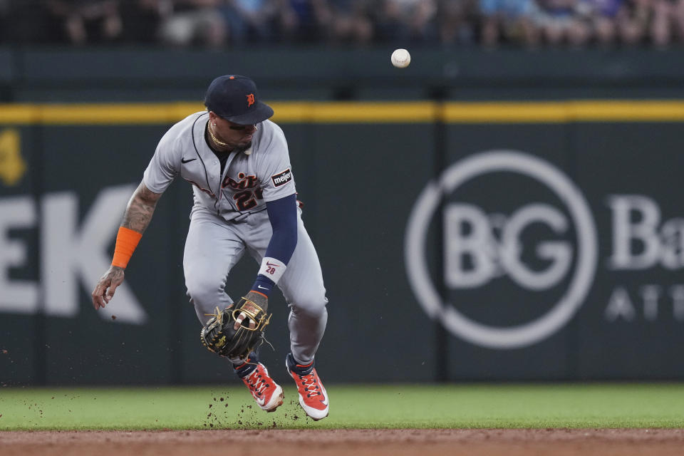 Detroit Tigers shortstop Javier Baez commits an error, allowing Texas Rangers' Leody Taveras to reach first base during the third inning of a baseball game in Arlington, Texas, Wednesday, June 28, 2023. (AP Photo/LM Otero)