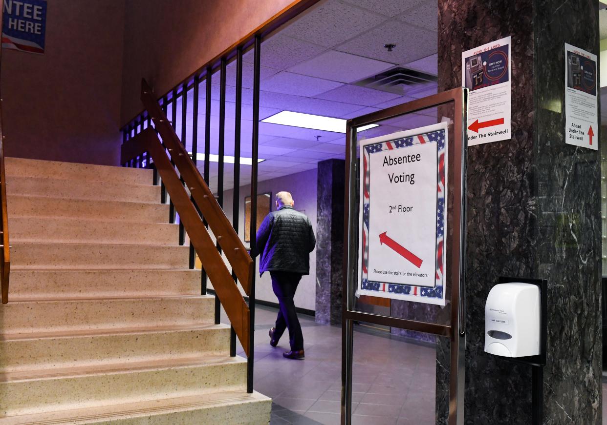 A sign pointing the way to absentee voting stands in the lobby on Wednesday, March 30, 2022, at the Minnehaha County Administrative Offices in Sioux Falls.