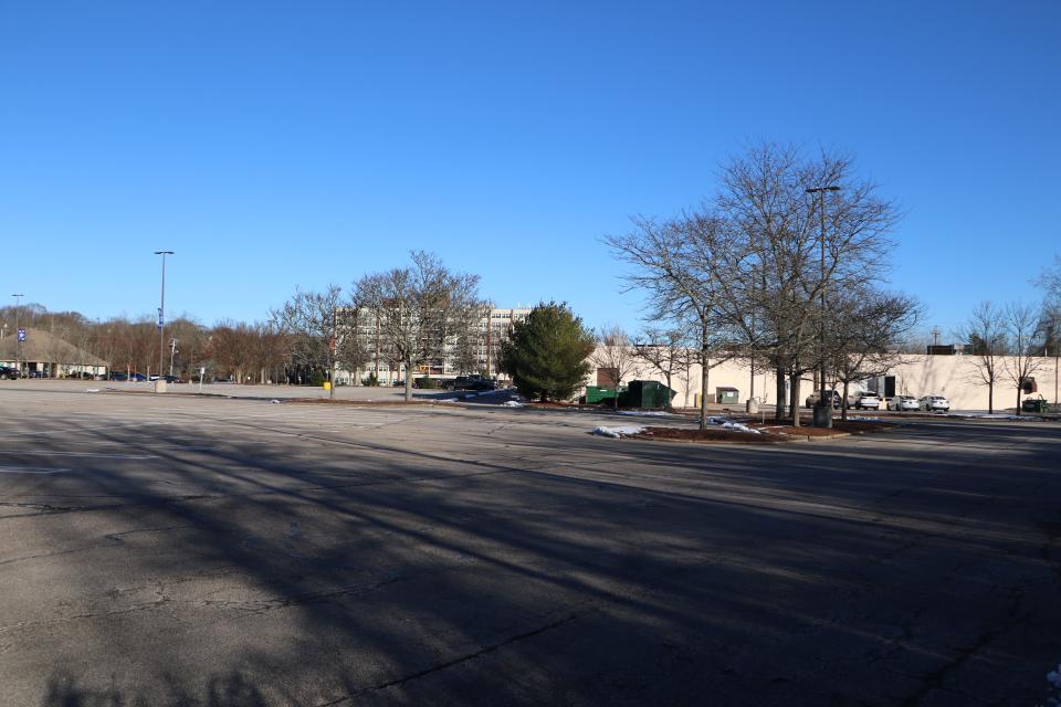 A consultant has suggested that this sprawling parking lot and a strip-mall to the right would make a good site for housing. The Cumberland Manor high-rise is across Mendon Road in the background.