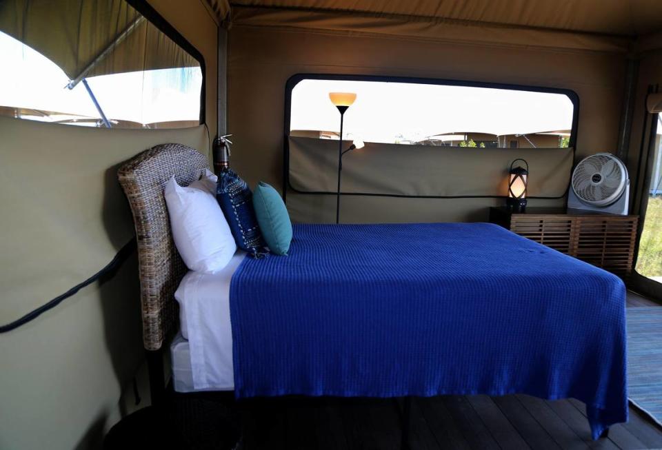 The eco-tents have real beds, fans and lamps where cell phones can be charged.