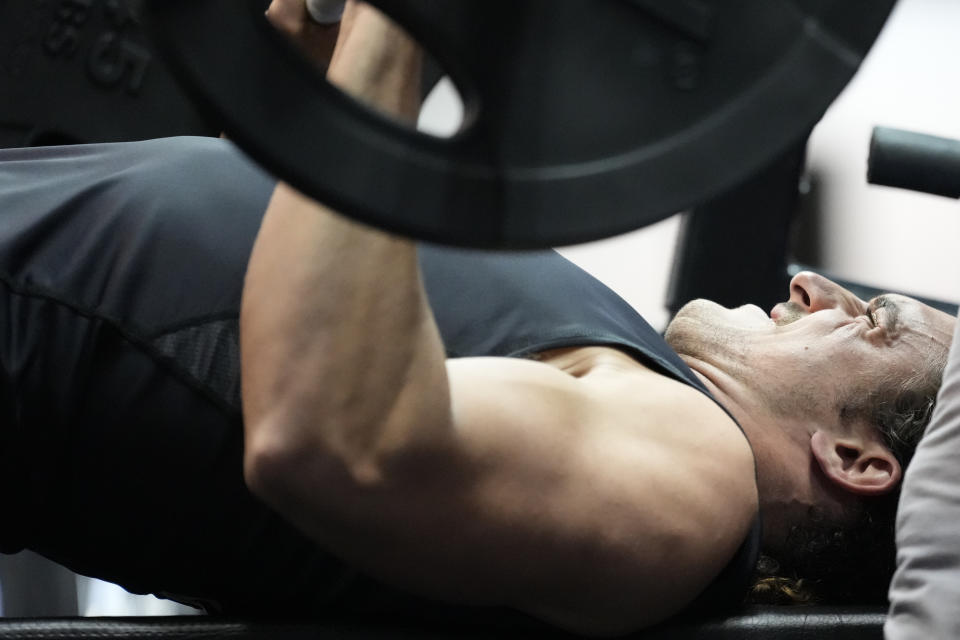 UCLA tight end Greg Dulcich competes on the bench press event at the 2022 NFL Combine, but other prospects are opting not to do it in Indianapolis. (AJ Mast/AP Images for NFL)