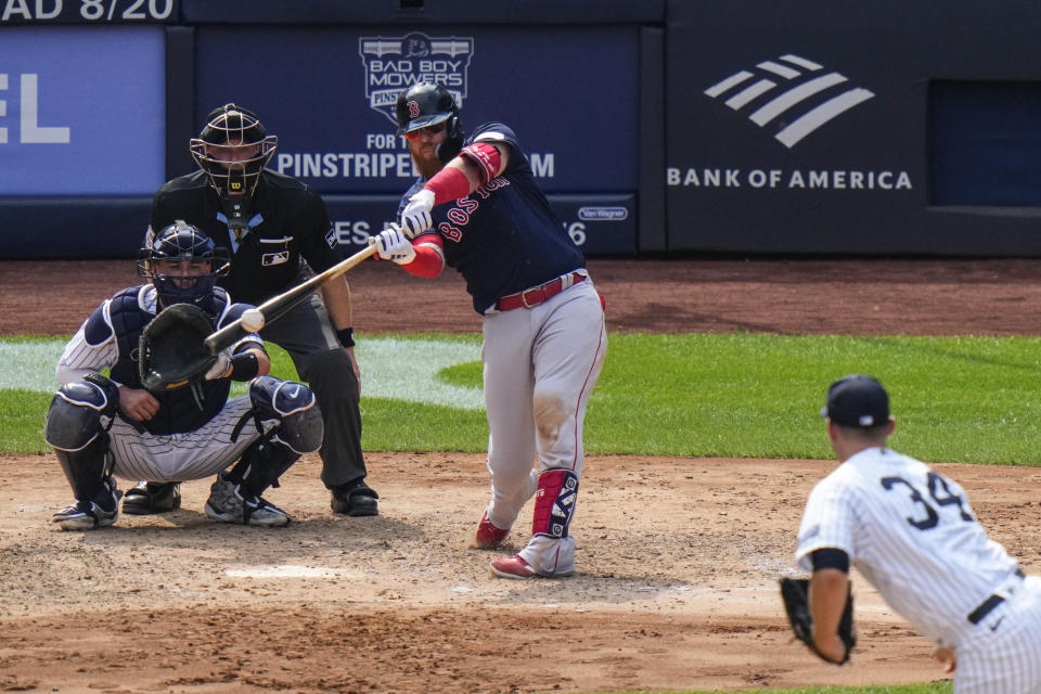 Boston Red Sox's Justin Turner, top right, hits a three-run home run during the seventh inning of a baseball game against the New York Yankees, Sunday, Aug. 20, 2023, in New York. (AP Photo/Frank Franklin II)