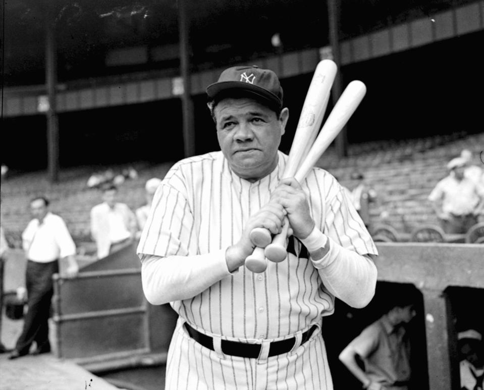 FILE - Retired Yankees slugger Babe Ruth warms up with three bats before stepping to the plate at New York's Yankee Stadium, August 21, 1942. (AP Photo/Tom Sande, File)