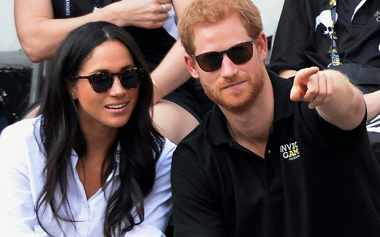 Meghan Markle and Prince Harry at the Invictus Games, where they were given his'n'hers jackets - The Canadian Press