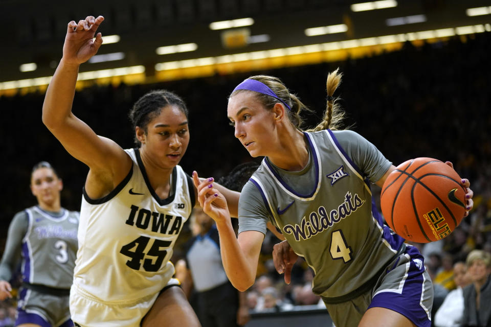 Kansas State guard Serena Sundell (4) drives to the basket past Iowa forward Hannah Stuelke (45) during the first half of an NCAA college basketball game, Thursday, Nov. 16, 2023, in Iowa City, Iowa. (AP Photo/Charlie Neibergall)