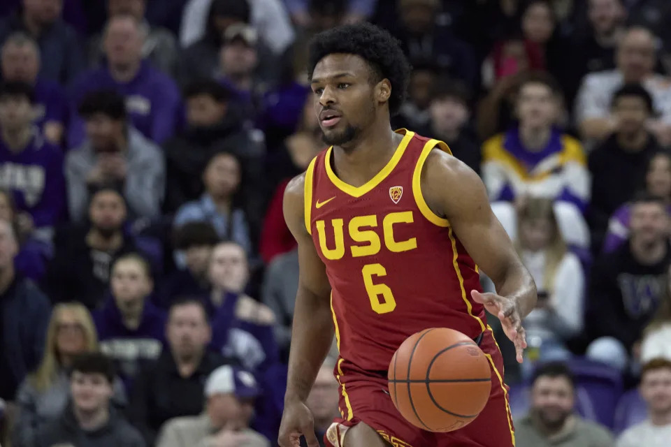 Southern Californiaguard Bronny James (6) dribbles the ball against Washington during the first half an NCAA college basketball game, Saturday, March 2, 2024, in Seattle. (AP Photo/John Froschauer)