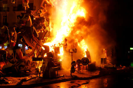 Figures that are part of a Fallas monument burn during the finale of the Fallas festival, which welcomes Spring and commemorates Saint Joseph's Day, in Valencia early March 20, 2019. REUTERS/Heino Kalis