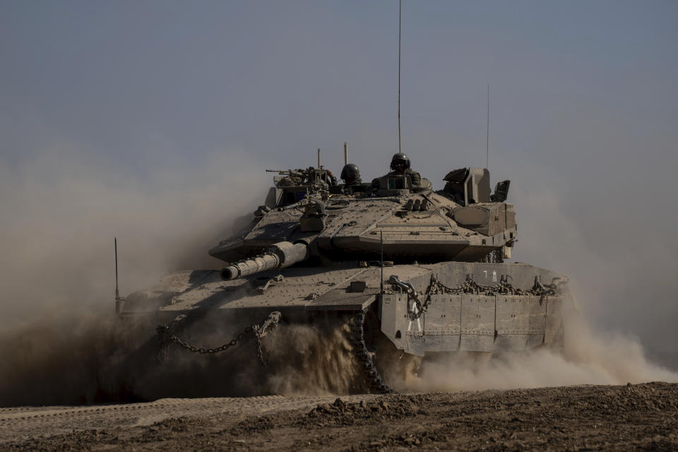 Israeli soldiers drive a tank near the Israeli-Gaza border, in southern Israel, Thursday, June 6, 2024. (AP Photo/Ohad Zwigenberg)