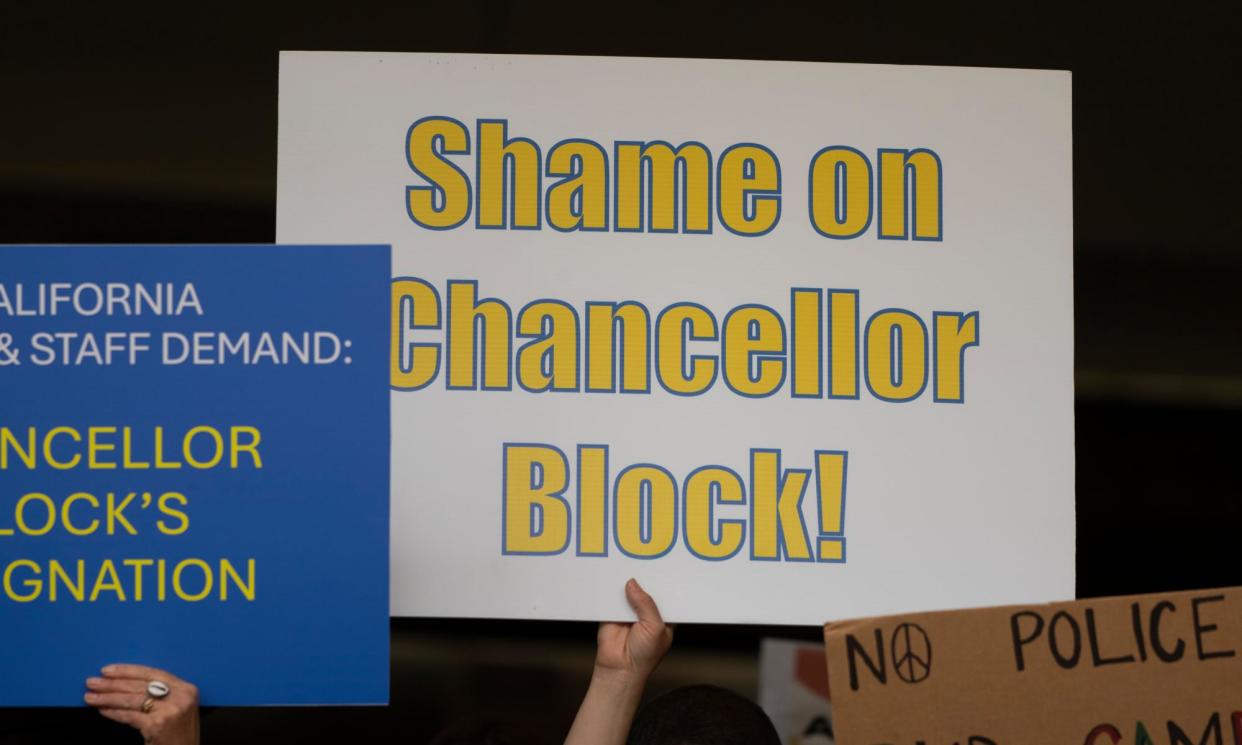 <span>A UCLA faculty member holds up a sign on Thursday.</span><span>Photograph: Jae C Hong/AP</span>