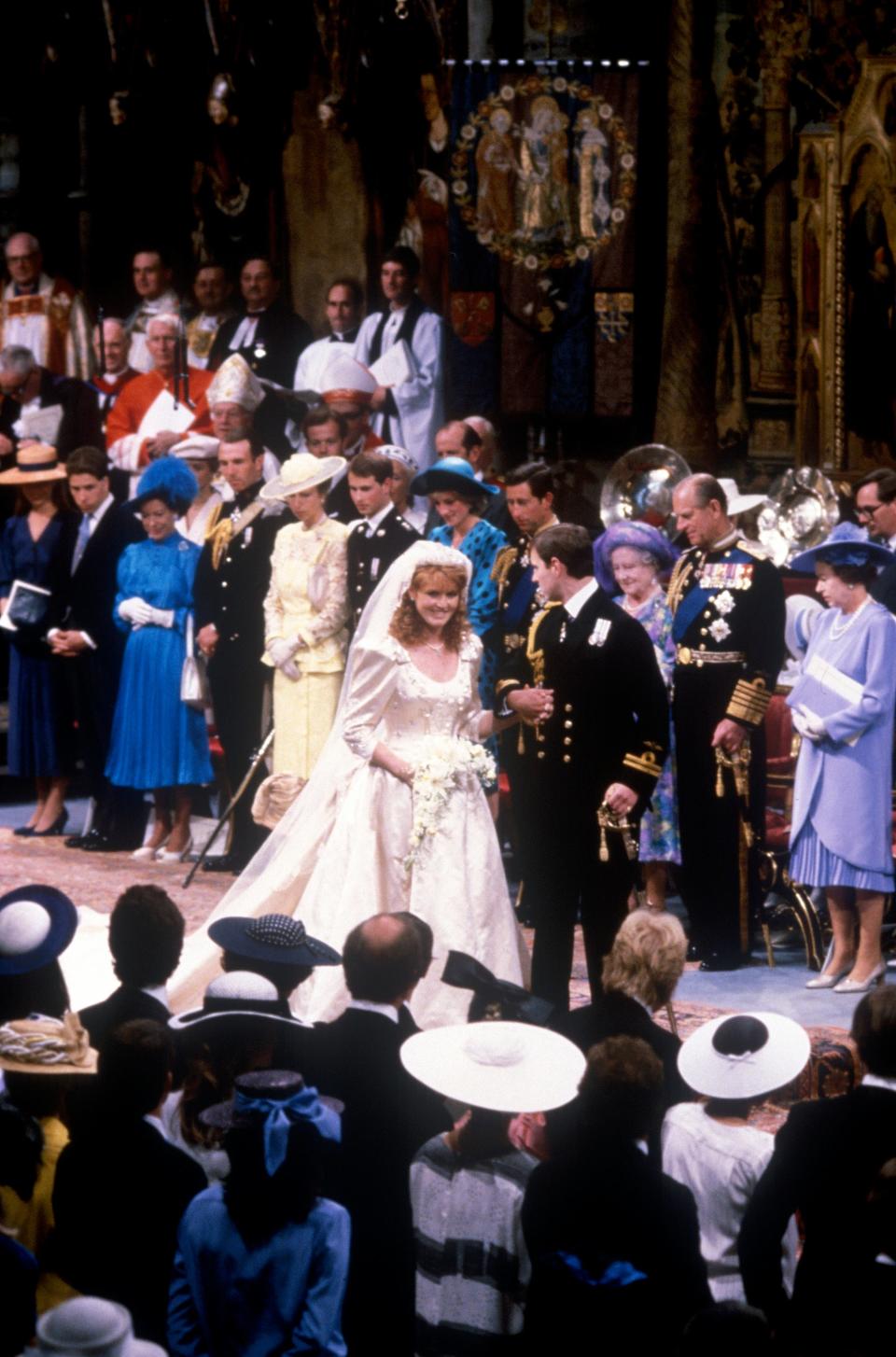 Sarah Ferguson and Prince Andrew walk down the aisle at their wedding at Westminster Abbey.