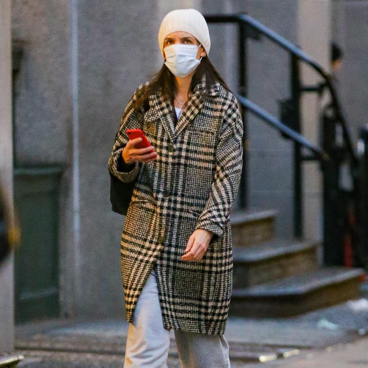  Katie Holmes wearing a plaid coat with sweatpants. 
