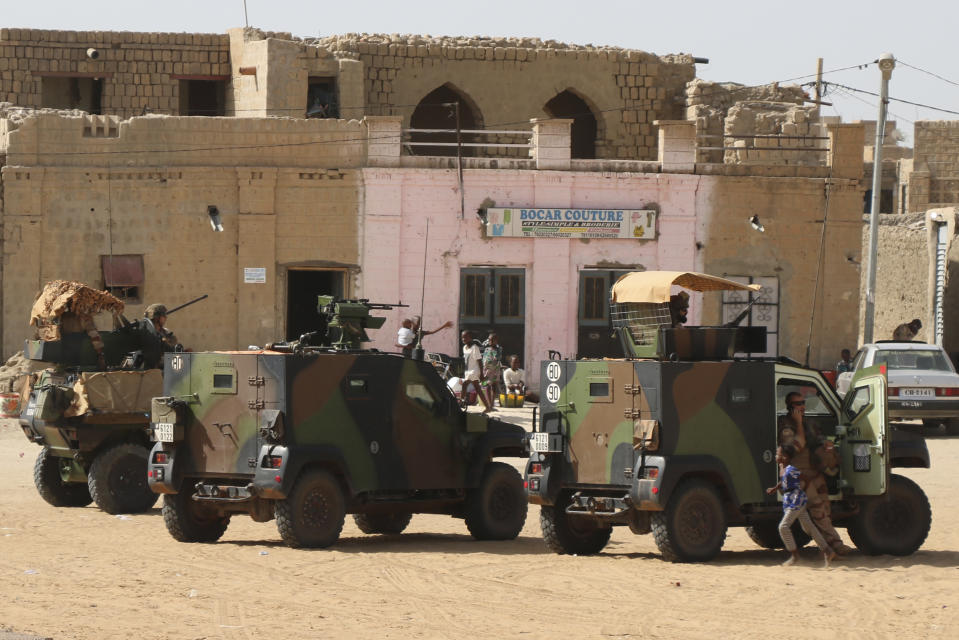 FILE - French Barkhane forces patrol the streets of Timbuktu, Mali, Sept. 29, 2021. French President Emmanuel Macron is to unveil on Monday Feb.27, 2023 his country's changing economic and military strategy in Africa in the coming years, as France's influence substantially declines on the continent. Macron is expected to call for a more balanced partnership with African nations, in a speech before he begins Wednesday an ambitious African trip to Gabon, Angola, the Republic of Congo and Congo. (AP Photo/Moulaye Sayah, file)