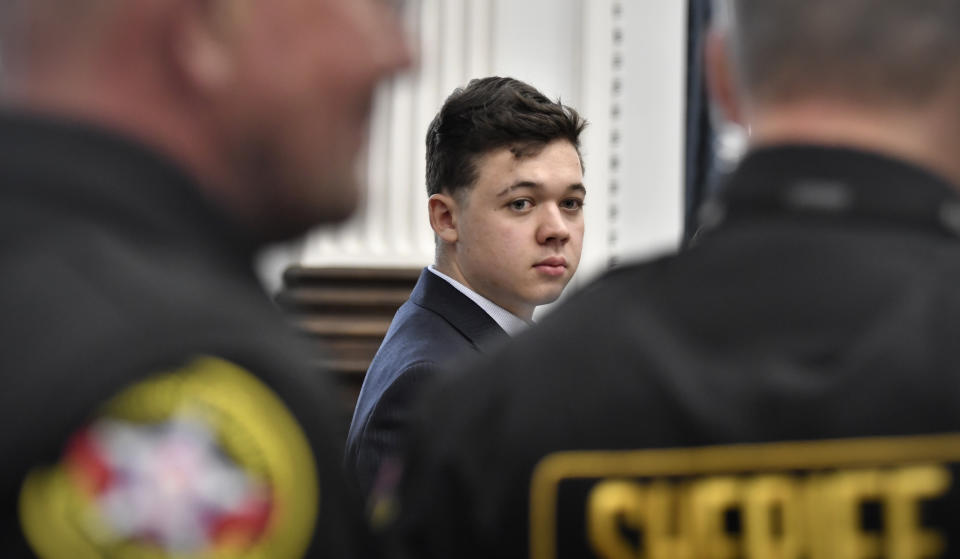 Kyle Rittenhouse, center, looks back as Kenosha County Sheriff's deputies enter the courtroom to escort him out of the room during a break in the trial at the Kenosha County Courthouse in Kenosha, Wis., on Friday, Nov. 5, 2021. Rittenhouse is accused of killing two people and wounding a third during a protest over police brutality in Kenosha, last year. (Sean Krajacic/The Kenosha News via AP, Pool)