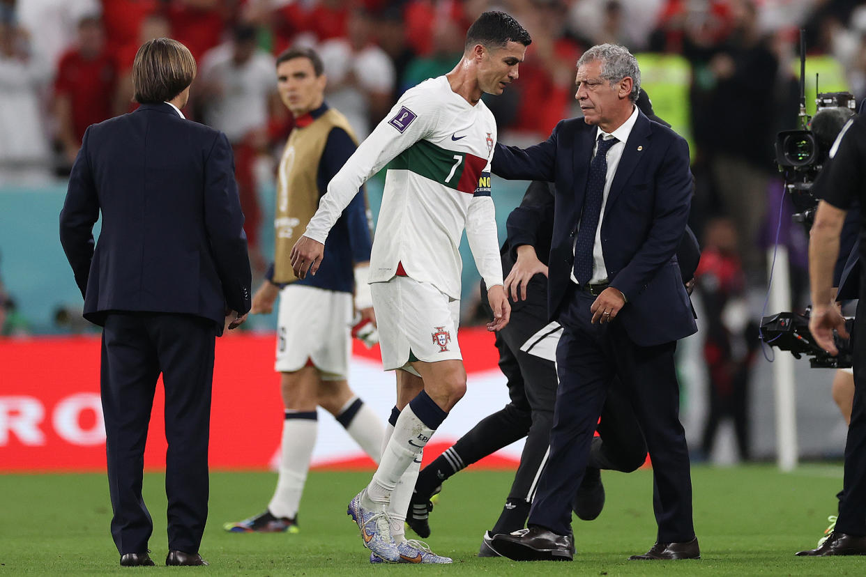 DOHA, QATAR - DECEMBER 10: Fernando Santos, Head Coach of Portugal pats the back of Cristiano Ronaldo after the team's defeat during the FIFA World Cup Qatar 2022 quarter final match between Morocco/Spain and Portugal/Switzerland at Al Thumama Stadium on December 10, 2022 in Doha, Qatar. (Photo by Michael Steele/Getty Images)