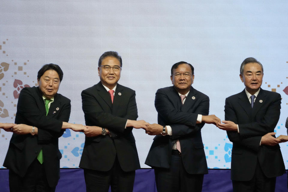 From left to right, Japan's Foreign Minister Yoshimasa Hayashi, South Korean Foreign Minister Park Jin, Cambodia's Foreign Minister Prak Sokhonn and Chinese Foreign Minister Wang Yi pose for a group photo during the ASEAN Plus Three Foreign Ministers' Meeting in Phnom Penh Cambodia, Thursday, Aug. 4, 2022. ( AP Photo/Heng Sinith)