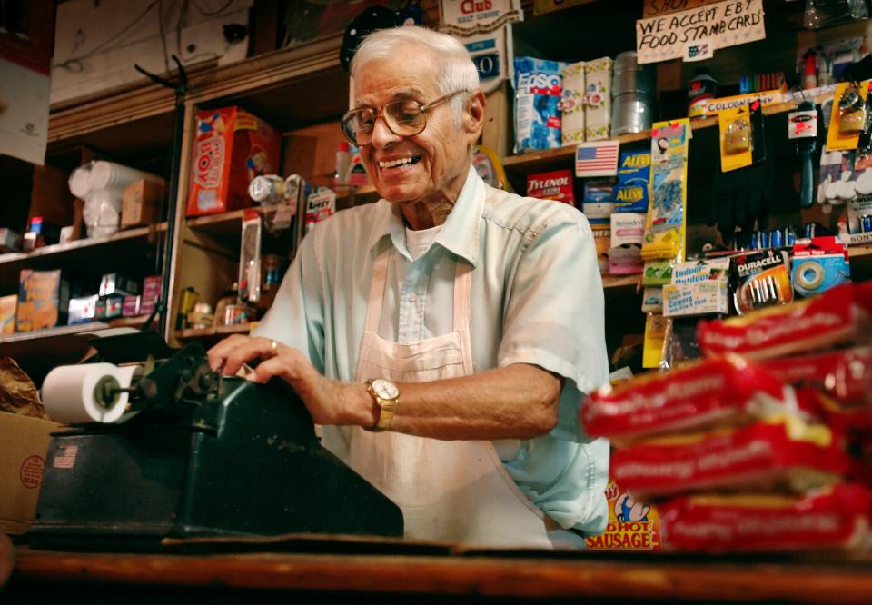 In this 2006 picture, Nick Debs tallies up a sale on a mechanical adding machine at Debs Store. He and his brother Gene, who was in hospice care at the time, had run the Eastside store for more than five decades.