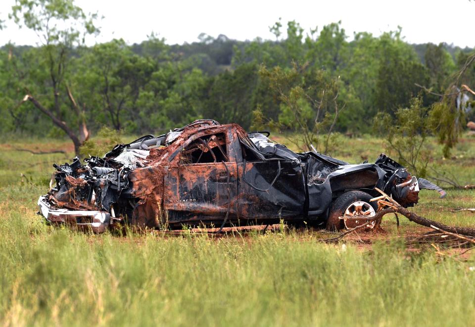The remains of a Chevrolet Silverado pickup lay in the grass of a pasture outside the remains of a home in Hodges Friday, May 3, 2024. Its tailgate was found over 100 yards away, resting against a barbed wife fence along the road, where it had damaged a mesquite tree. Homes and other buildings in the unincorporated Jones County community were damaged or destroyed by a tornado Thursday evening.