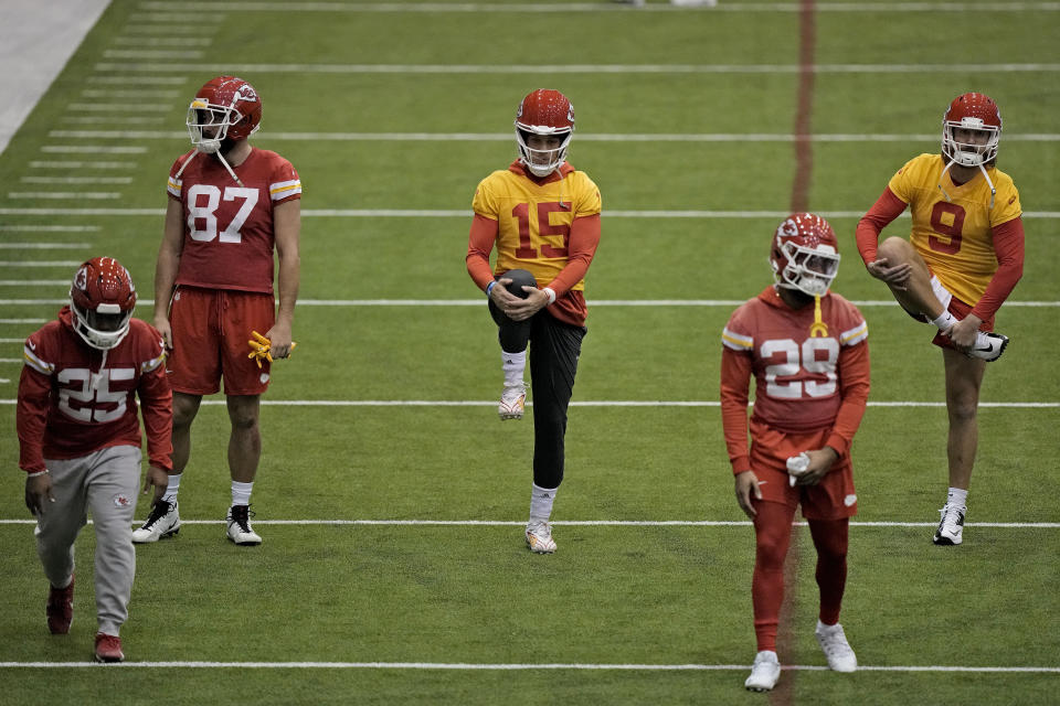 Kansas City Chiefs quarterback Patrick Mahomes (15) stretches with teammates during the NFL football team's practice Thursday, Jan. 25, 2024, in Kansas City, Mo. (AP Photo/Charlie Riedel)