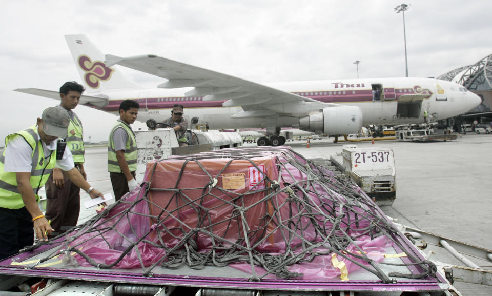 FILE- Airport cargo crew stand by a crate containing the body of Japanese journalist Kenji Nagai who was killed during military crackdown on street protests in Yangon, Myanmar, on his arrival in Bangkok, Thailand on Oct. 3, 2007. Nagai's camera, which went missing when he died, was recently found by an exiled Myanmar media group and turned over to his family at a ceremony in Bangkok on Wednesday, April 26, 2023. (AP Photo/Sakchai Lalit, File)