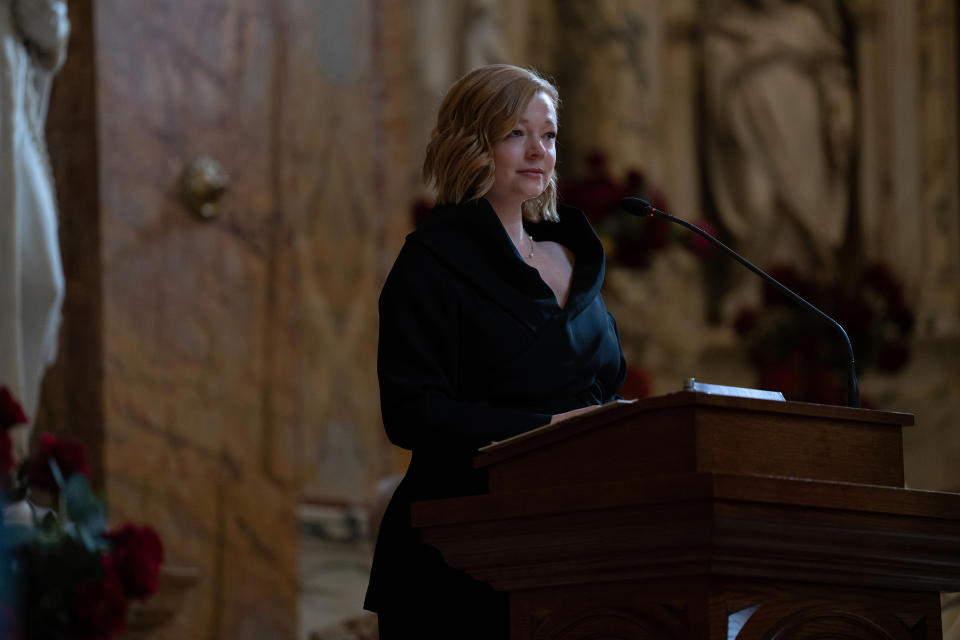 Sarah Snook as Shiv Roy standing at a podium at her father's funeral in Episode 9 of Season 4 of "Succession"