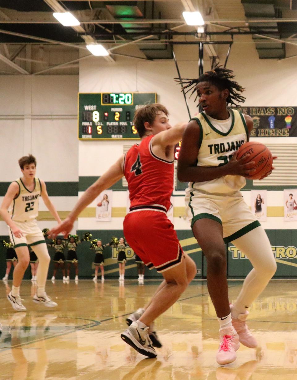 West High's Kareem Earl (24) posting up Western Dubuque's Caleb Klein.