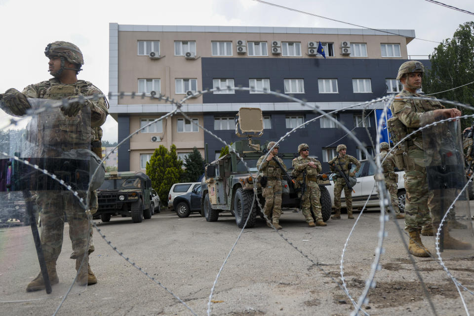 FILE - US soldiers, part of the peacekeeping mission in Kosovo KFOR guard a municipal building in the town of Leposavic, northern Kosovo, on May 29, 2023. The European Union has summoned the leaders of Serbia and Kosovo for emergency talks on Thursday June 22, 2023 to try to bring an end to a series of violent clashes near their border that is fueling fears of a return to open conflict. (AP Photo/Marjan Vucetic, File)