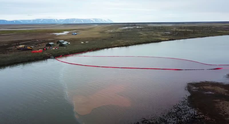 Rescuers work at the site of a huge leak of fuel into the river after an accident at a power plant outside Norilsk