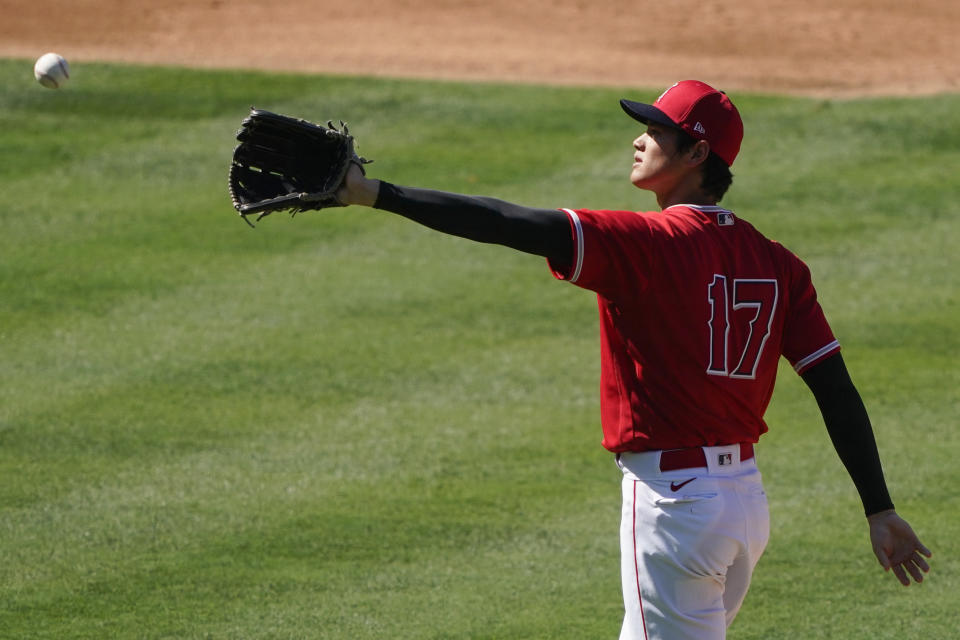 Los Angeles Angels pitcher Shohei Ohtani catches a ball during an intrasquad game at baseball practice at Angel Stadium on Tuesday, July 7, 2020, in Anaheim, Calif. (AP Photo/Ashley Landis)