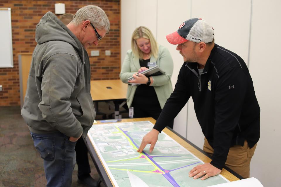 Pat Dressen with HDR explains to a Sioux Falls citizen the construction phases for the Benson Road / I-229 interchange project during an open house on Monday, March 27, at the public library in downtown Sioux Falls.