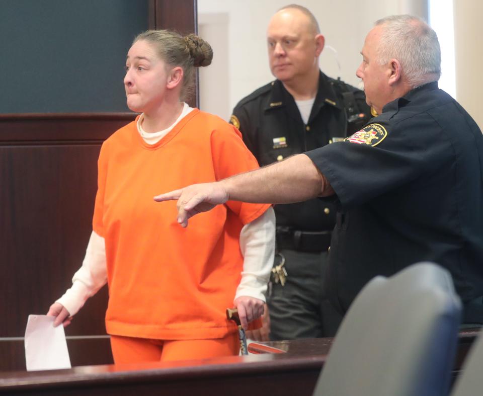 Julianne Shead is escorted into Judge Laurie Pittman's courtroom Wednesday by Portage County Sheriff's deputies.