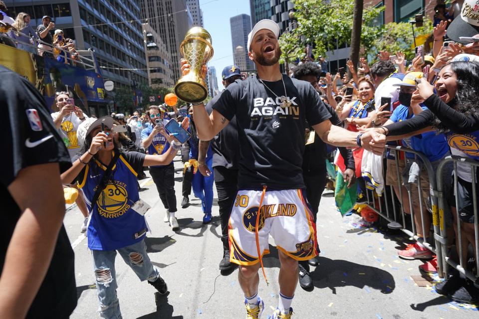 Steph Curry interacts with fans at the victory parade.