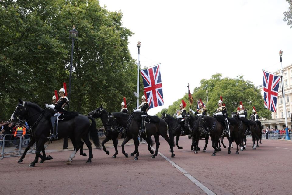 Royal guardsmen and horses pass by on the day the coffin of Britain’s Queen Elizabeth is transported from Buckingham Palace to The Palace Of Westminster (Getty Images)