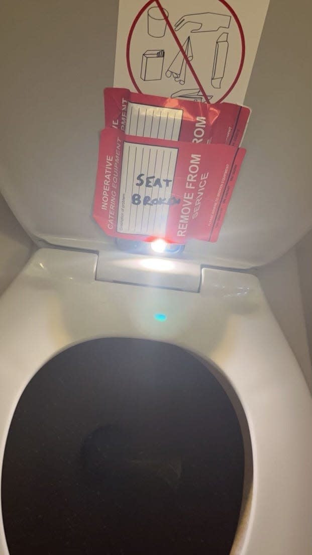 A cellphone reportedly taped to the inside of a toilet on an American Airlines flight.