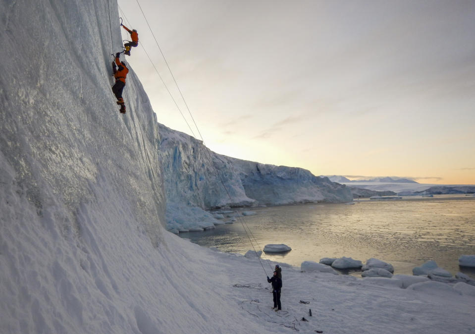 Two men are seen climbing in Antarctica.