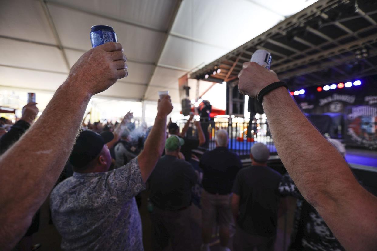 Patrons raise their drinks in support of the troops ahead of a wet T-shirt competition in Dirty Harry’s Pub in Daytona, FL during Bike Week on March 5, 2021. (Sam Thomas/Orlando Sentinel)