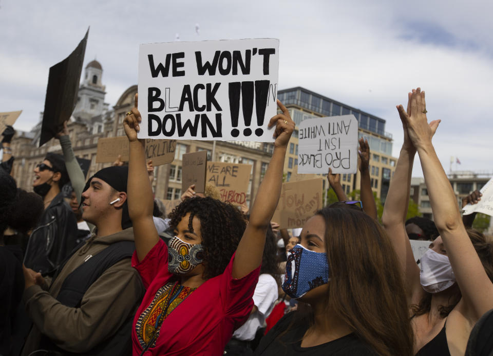 People take part in a Black Lives Matter protest in Amsterdam, Netherlands, Monday, June 1, 2020, to protest against the recent killing of George Floyd, a black man who died in police custody in Minneapolis, U.S.A., after being restrained by police officers on Memorial Day. (AP Photo/Peter Dejong)