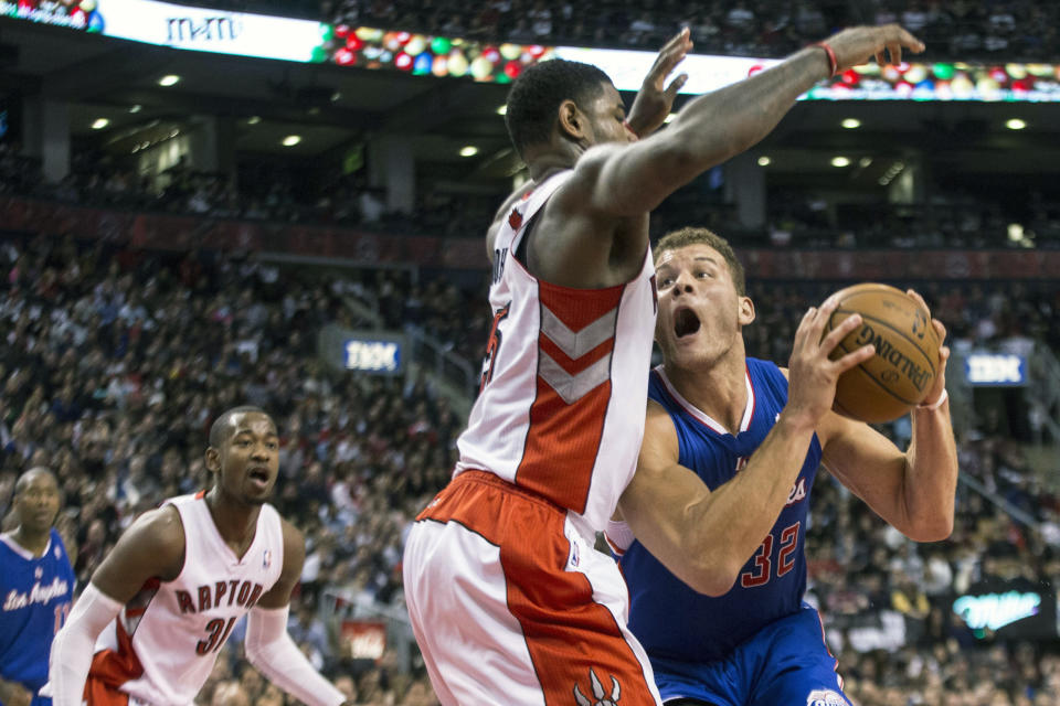 Los Angeles Clippers' Blake Griffin, right, drives at Toronto Raptors' Amir Johnson during the first half of an NBA basketball game, Saturday, Jan. 25, 2014 in Toronto. (AP Photo/The Canadian Press, Chris Young)