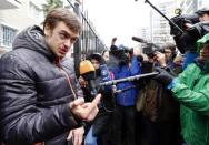 Pyotr Verzilov (L), husband of protest group Pussy Riot band member Nadezhda Tolokonnikova, speaks to journalists in front of a police station in Adler during the 2014 Sochi Winter Olympics, February 18, 2014. REUTERS/Shamil Zhumatov