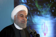In this photo released by the official website of the office of the Iranian Presidency, President Hassan Rouhani speaks in a ceremony inaugurating a new highway that connects Tehran to the north of the country, Iran, Tuesday, Feb. 25, 2020. Rouhani sought to reassure the nation in a speech on Tuesday, calling the new coronavirus an "uninvited and inauspicious passenger." "We will get through corona," Rouhani said. "We will get through the virus." (Iranian Presidency Office via AP)