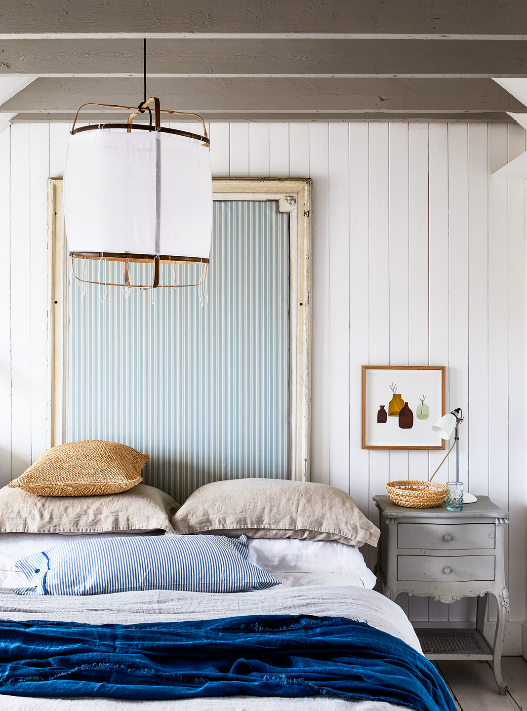 coastal inspired bedroom with diy headboard crafted from an antique mirror frame and striped upholstery maritime feel, nautical