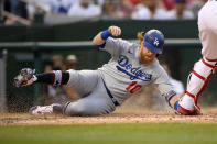 Los Angeles Dodgers' Justin Turner (10) slides home to score during the fourth inning of the team's baseball game against the Washington Nationals, Saturday, July 3, 2021, in Washington. (AP Photo/Nick Wass)