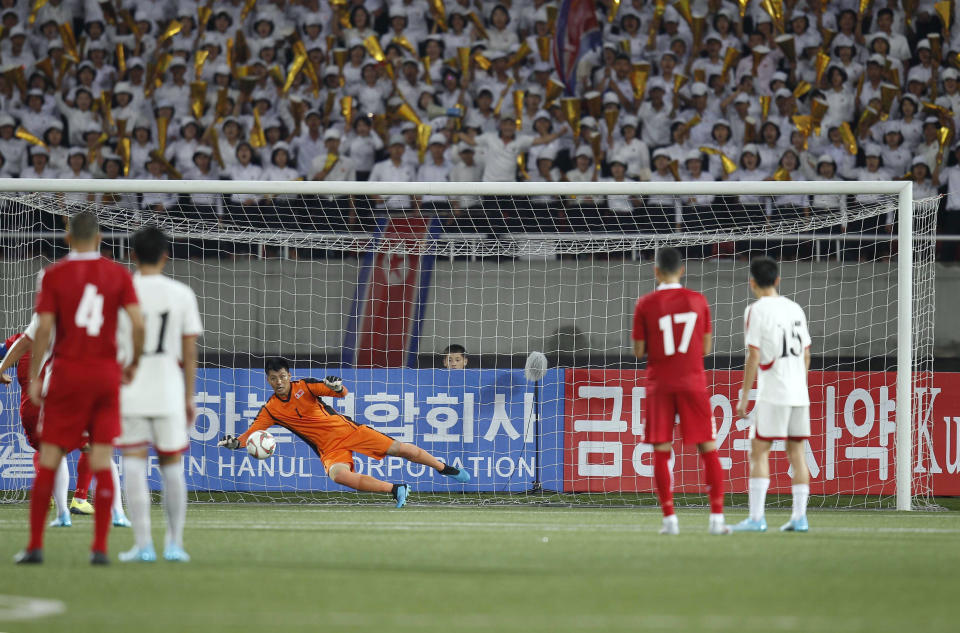 North Korea's goalkeeper An Tae Song saves a penalty during the World Cup Group H qualifying soccer match between North Korea and Lebanon at the Kim Il Sung Stadium in Pyongyang, Thursday, Sept. 5, 2019. North Korea won the game 2-0. (AP Photo/Jon Chol Jin)