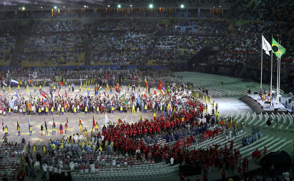 <p>Athletes from Canada come into the arena to take their seats, as the Olympics flag and the Brazilian national flag is seen at one end of the arena during the 2016 Rio Olympics closing ceremony on August 21, 2016. (REUTERS/Yves Herman) </p>